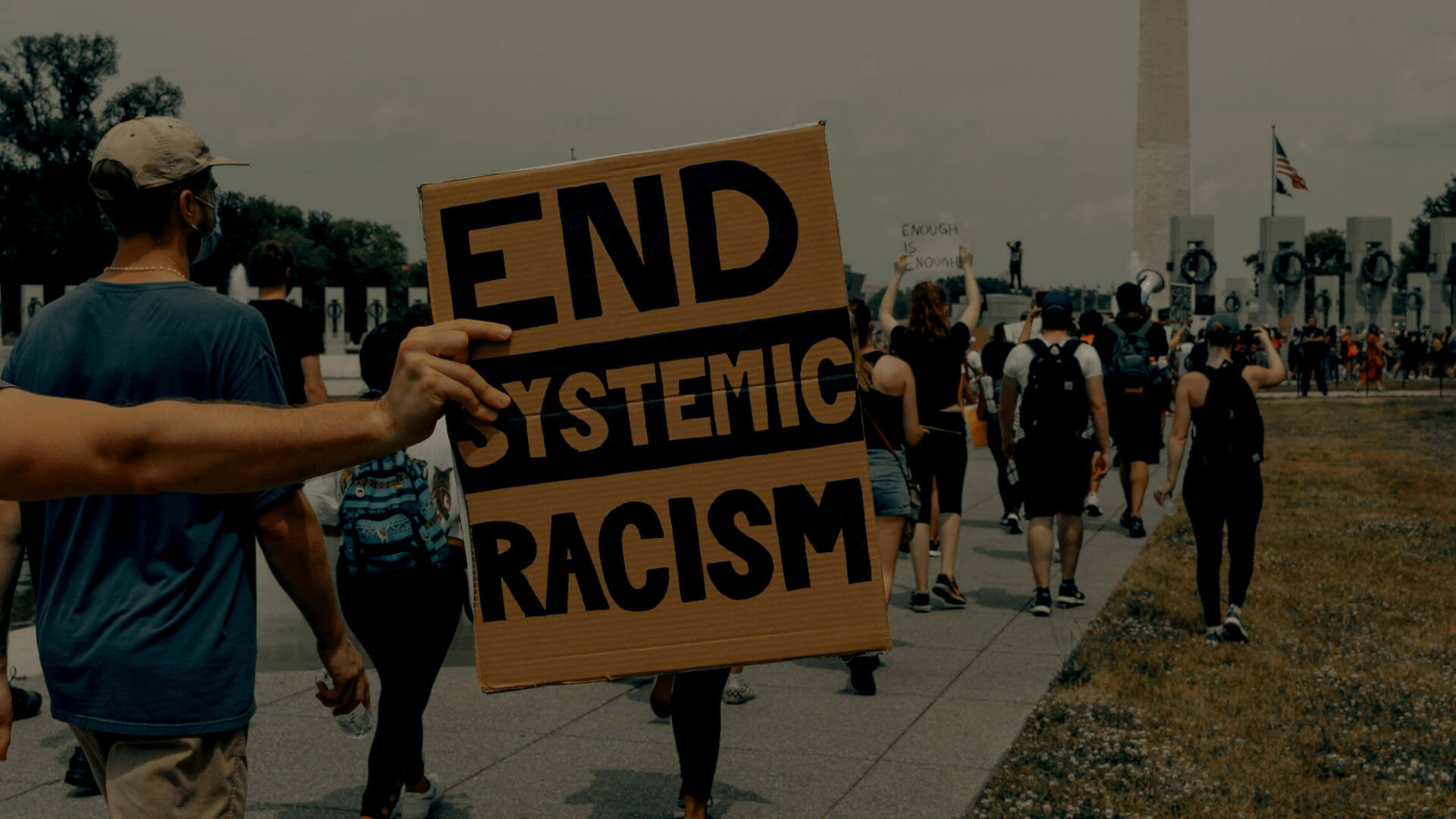 person holding end systemic racism sign