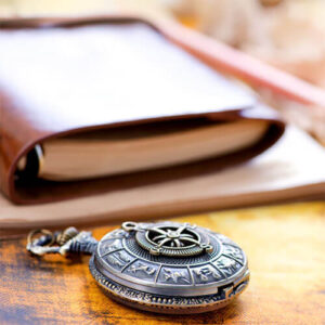 book and compass on table