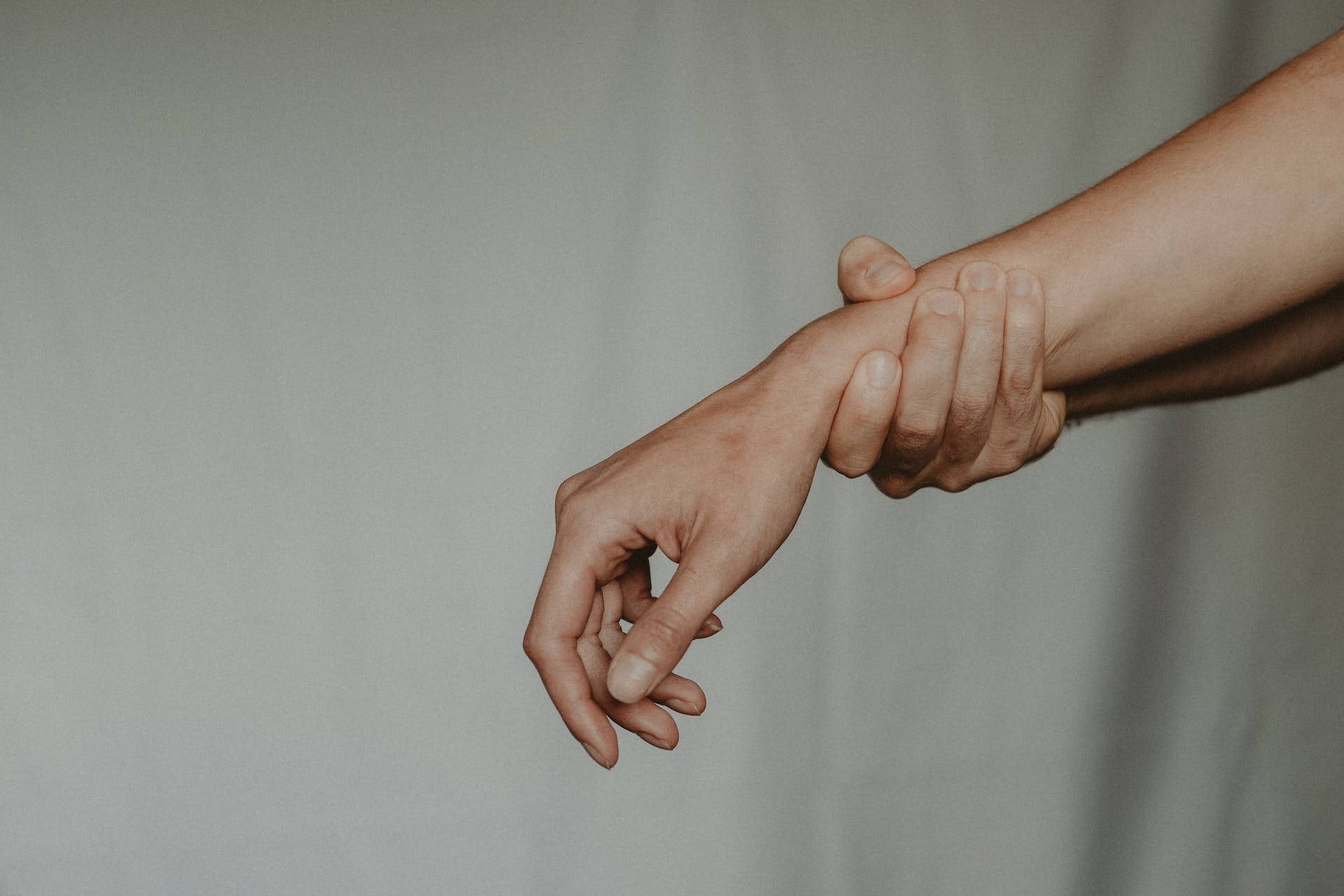 chronic pain sufferer holding wrist